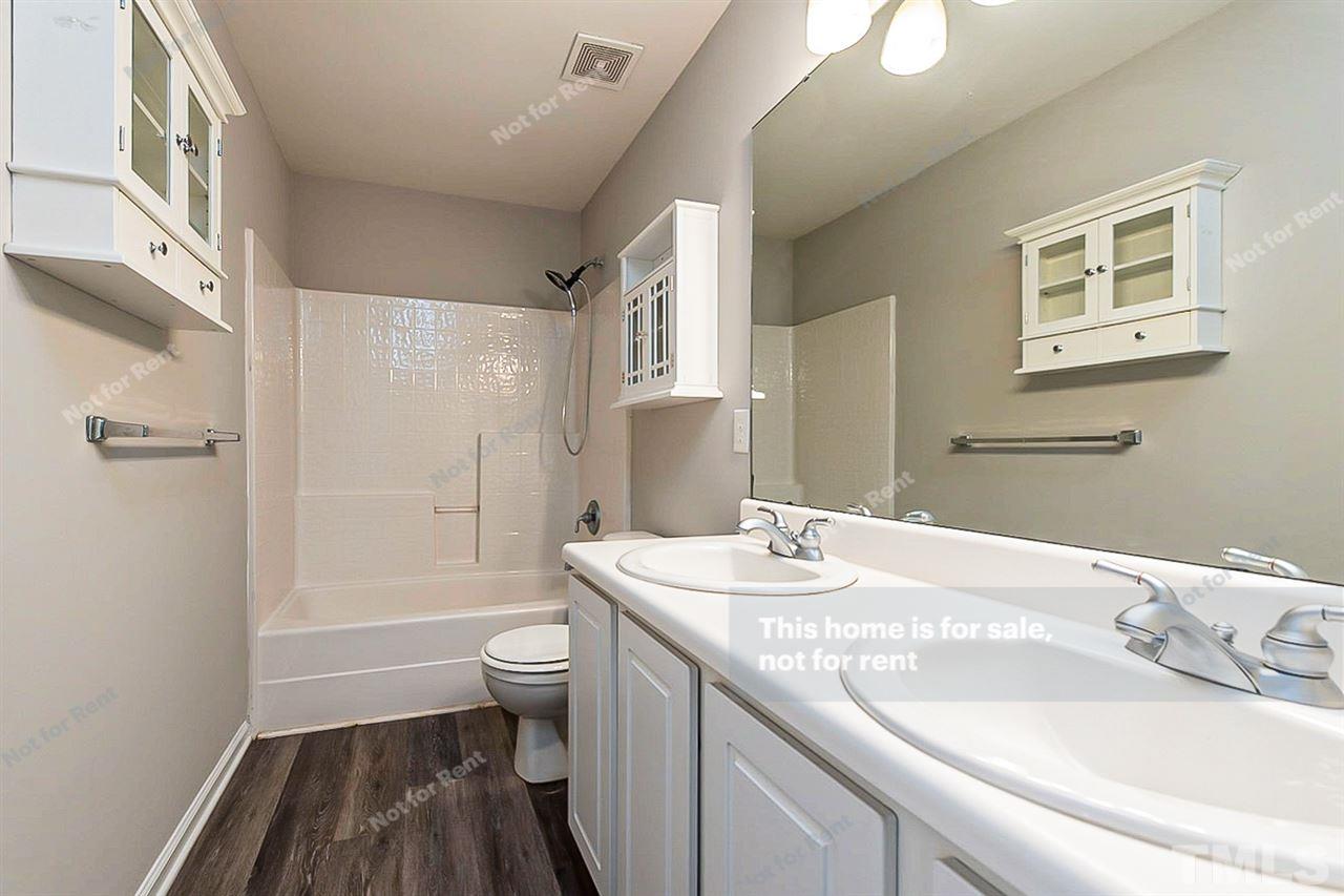 5304 Neuse Forest Road Raleigh, NC 27616 - Photo 6 of 26 a bathroom with a sink a toilet and shower
