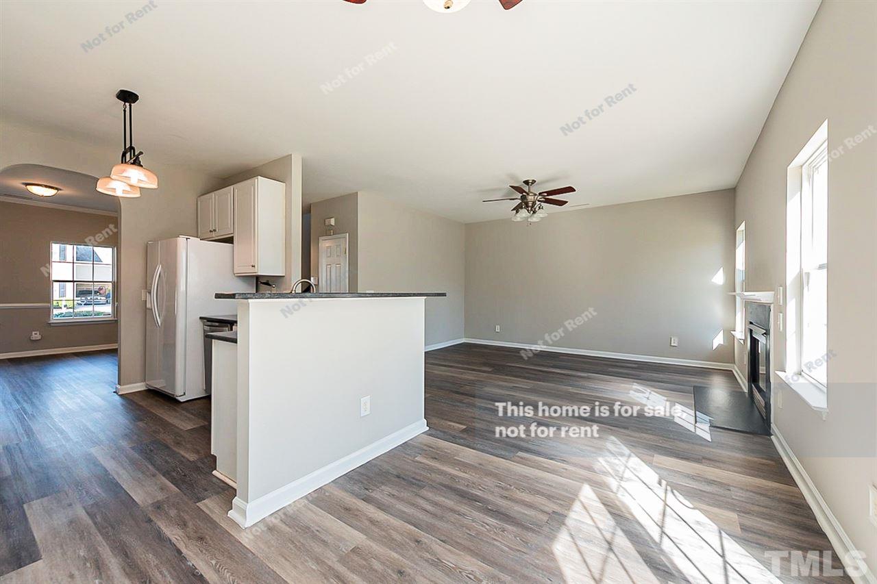 5304 Neuse Forest Road Raleigh, NC 27616 - Photo 9 of 26 a view of a kitchen cabinets and wooden floor