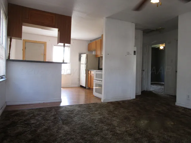 a view of a kitchen with a sink and a refrigerator
