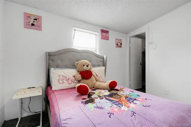 a bed room with a bed and two room