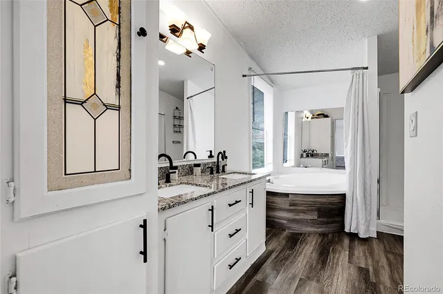 a bathroom with a double vanity sink mirror and