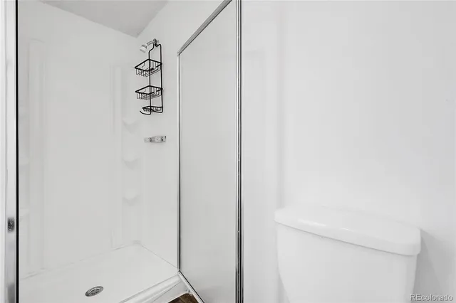 a bathroom with a shower and a sink