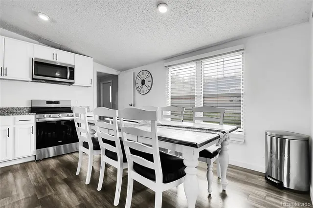 a view of a kitchen with dining table and chairs