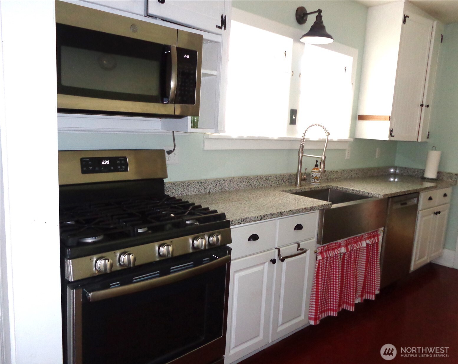 1639 22nd Avenue Longview, WA 98632 - Photo 11 of 35 a kitchen with granite countertop a stove top oven and sink