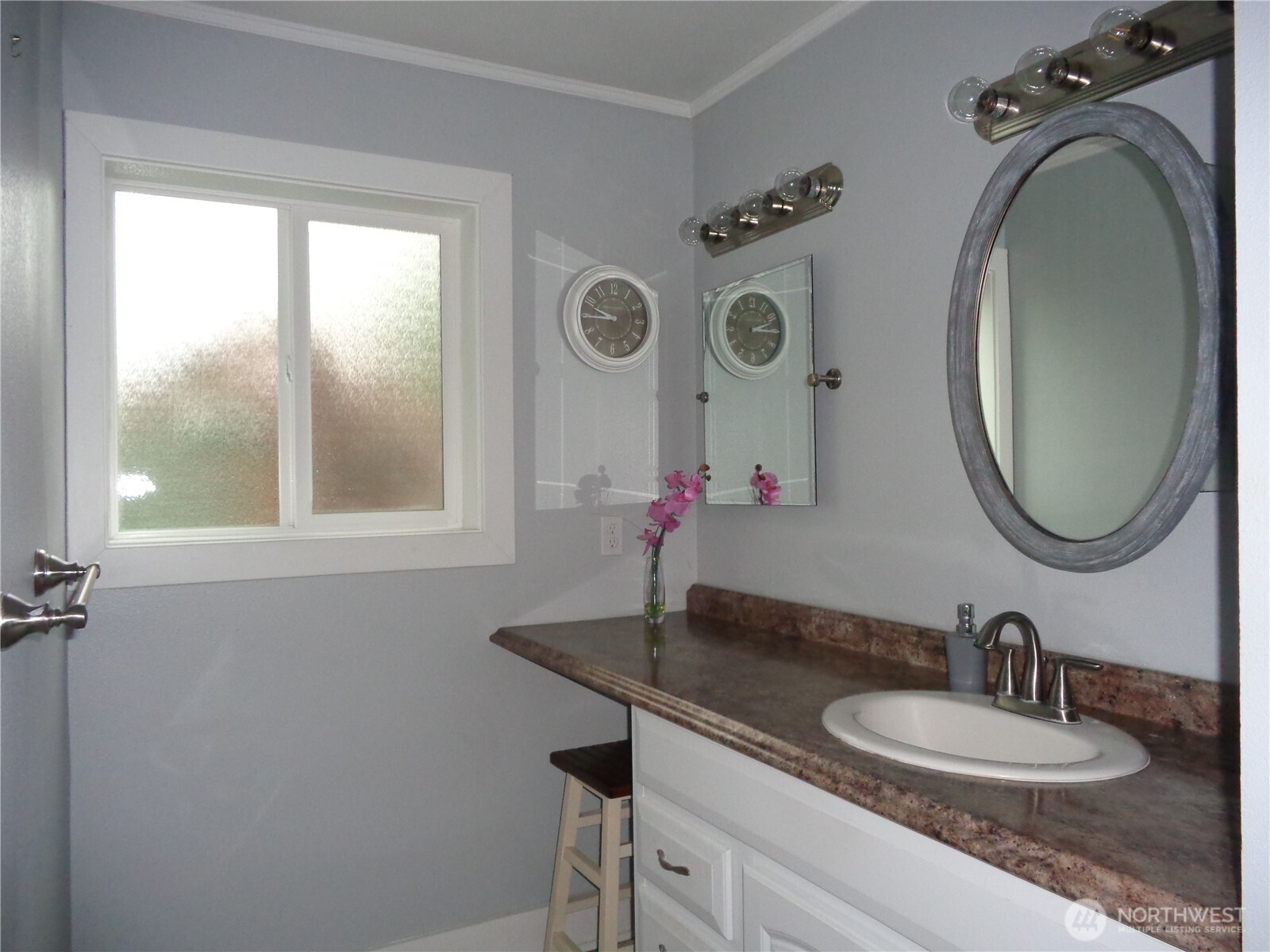 1639 22nd Avenue Longview, WA 98632 - Photo 14 of 35 a bathroom with a granite countertop sink a large mirror and a window