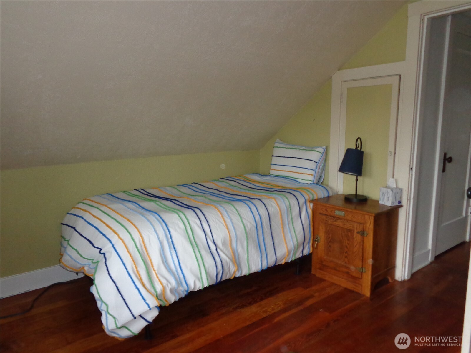 1639 22nd Avenue Longview, WA 98632 - Photo 22 of 35 a bedroom with a bed and wooden floor