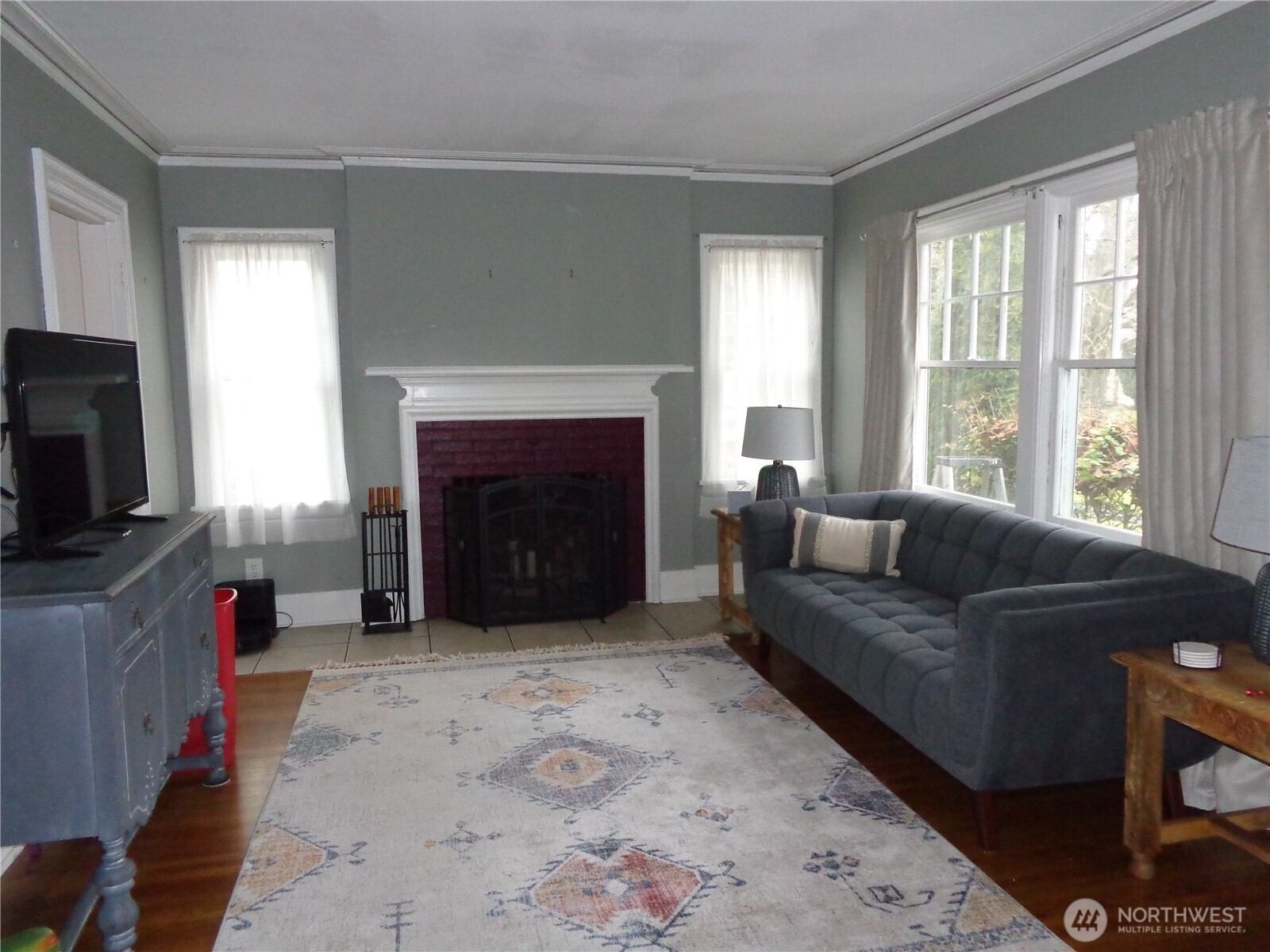 1639 22nd Avenue Longview, WA 98632 - Photo 5 of 35 a living room with furniture a flat screen tv and a fireplace