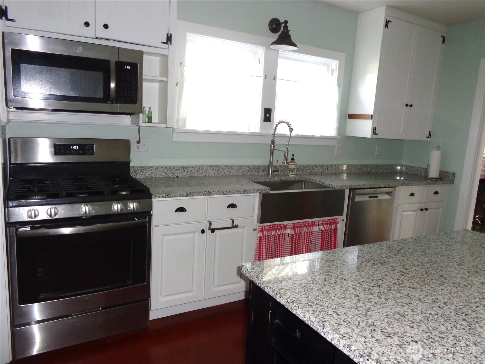 1639 22nd Avenue Longview, WA 98632 - Photo 9 of 35 a kitchen with stainless steel appliances granite countertop a sink stove and microwave