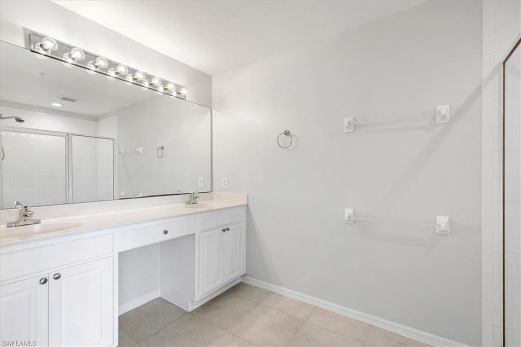 839 Hampton Circle, Unit 149 Naples, FL 34105 - Photo 13 of 22 a bathroom with a double vanity sink mirror and double