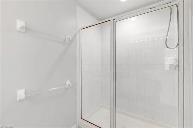 a bathroom with a glass shower door