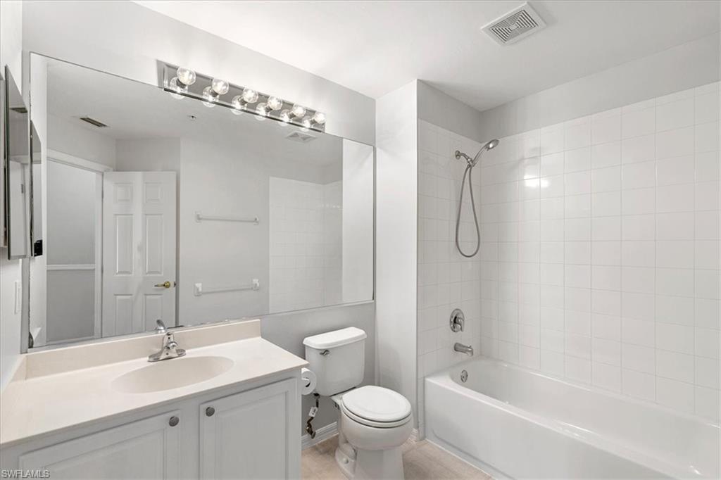 839 Hampton Circle, Unit 149 Naples, FL 34105 - Photo 17 of 22 a bathroom with a sink a toilet and shower
