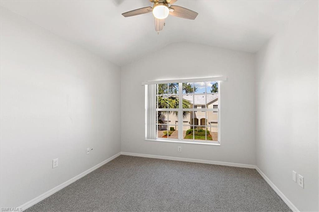 839 Hampton Circle, Unit 149 Naples, FL 34105 - Photo 18 of 22 an empty room with window and ceiling fan
