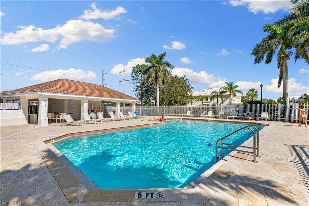 839 Hampton Circle, Unit 149 Naples, FL 34105 - Photo 21 of 22 a view of a swimming pool with a patio