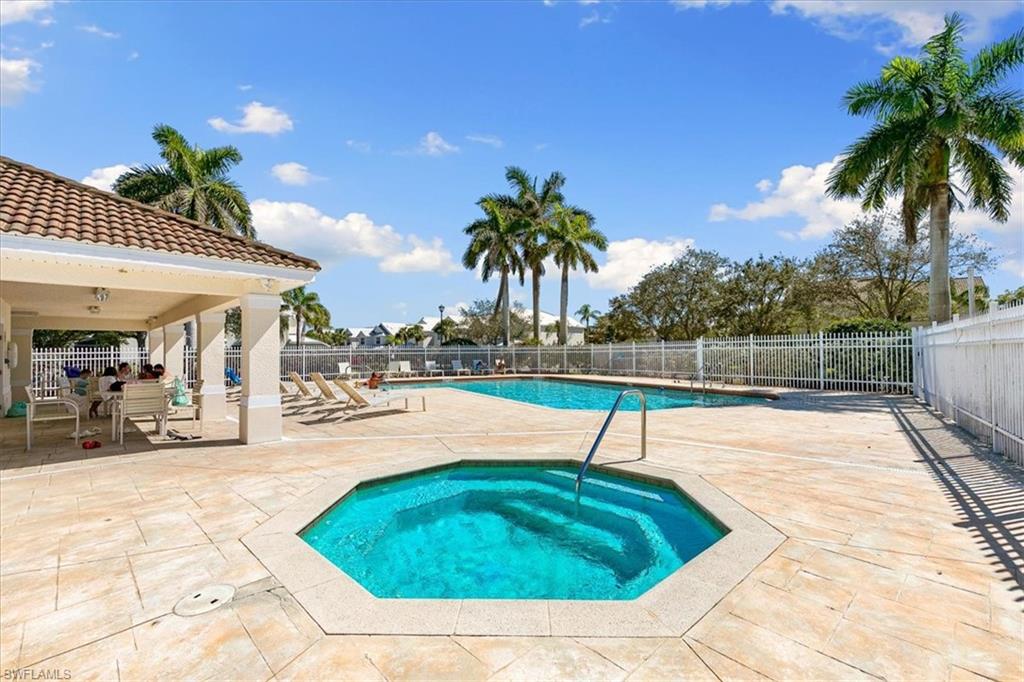 839 Hampton Circle, Unit 149 Naples, FL 34105 - Photo 22 of 22 a swimming pool with outdoor seating and yard