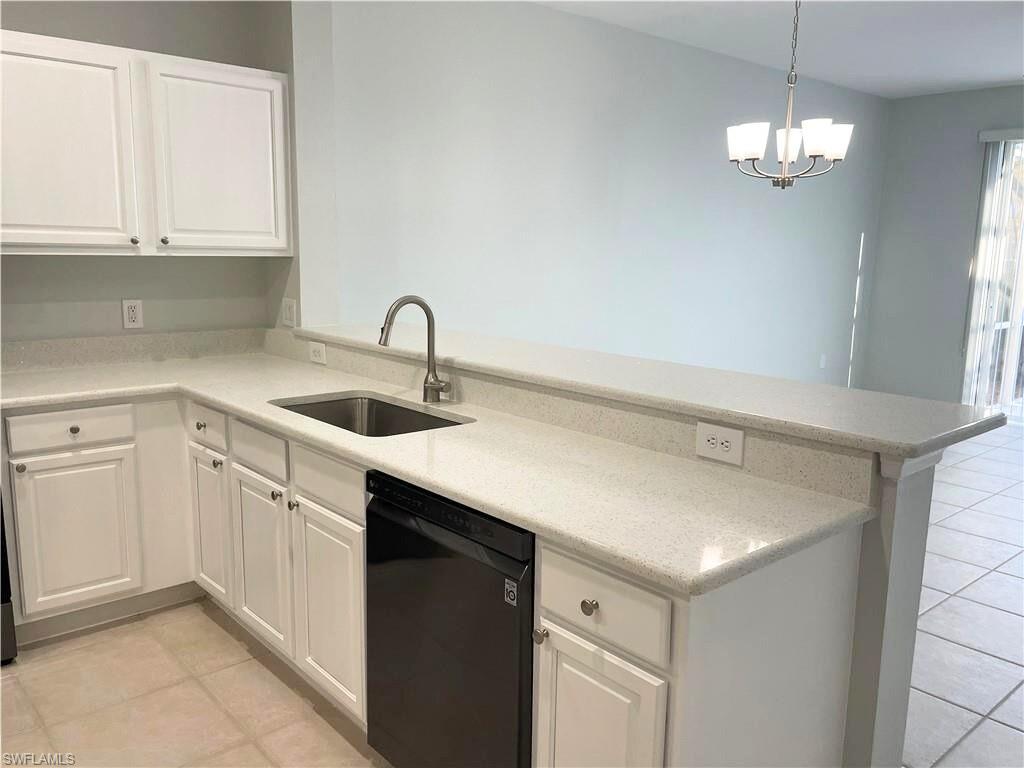 839 Hampton Circle, Unit 149 Naples, FL 34105 - Photo 6 of 22 a kitchen with a sink dishwasher and cabinets