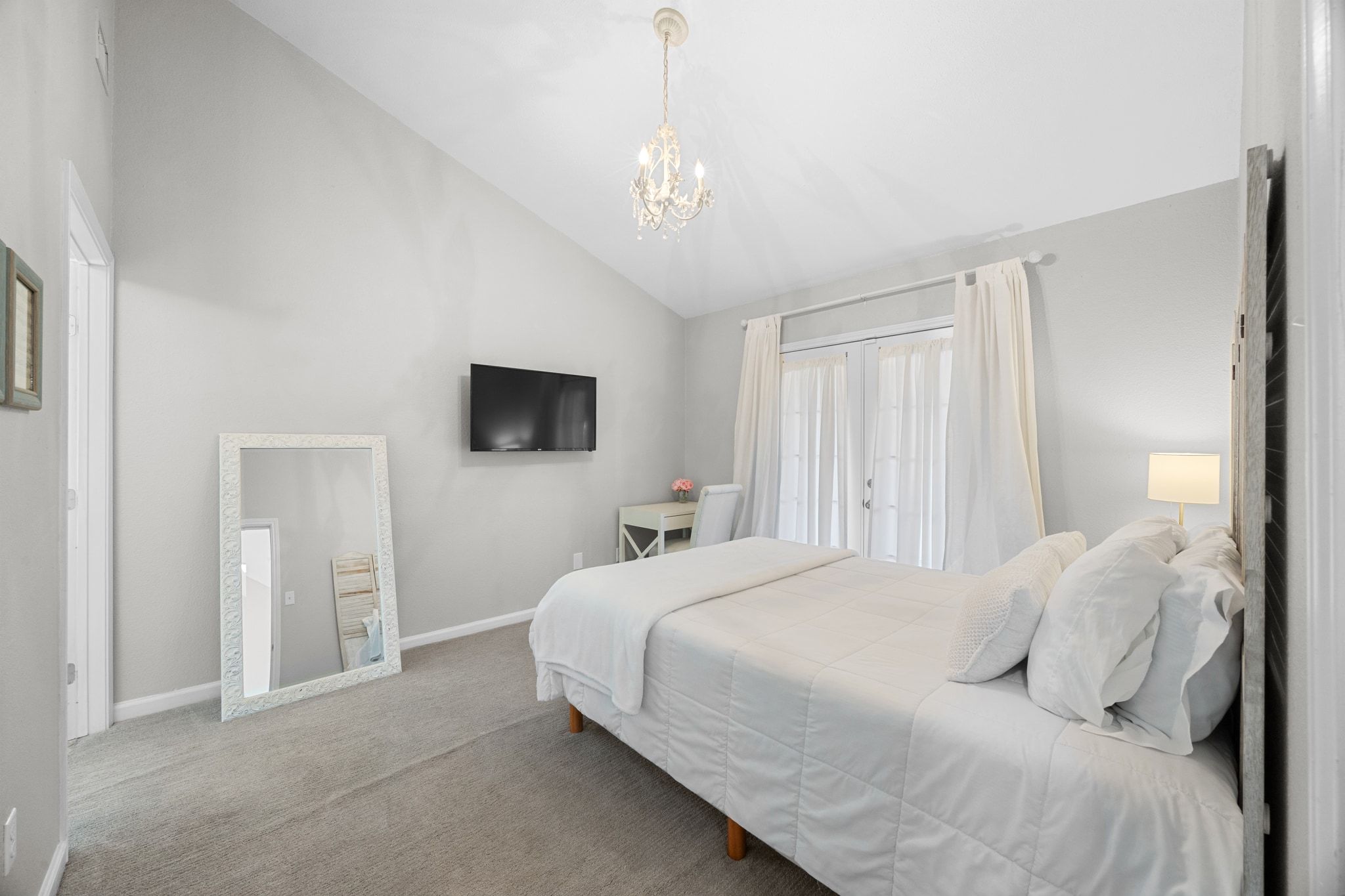 6305 Weeks Cove Austin, TX 78727 - Photo 12 of 30 Bedroom featuring carpet, a chandelier, and high vaulted ceiling