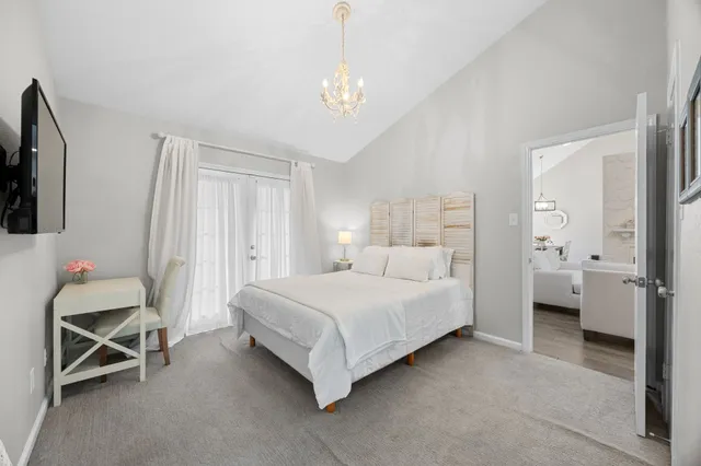 a bedroom with a bed and a chandelier