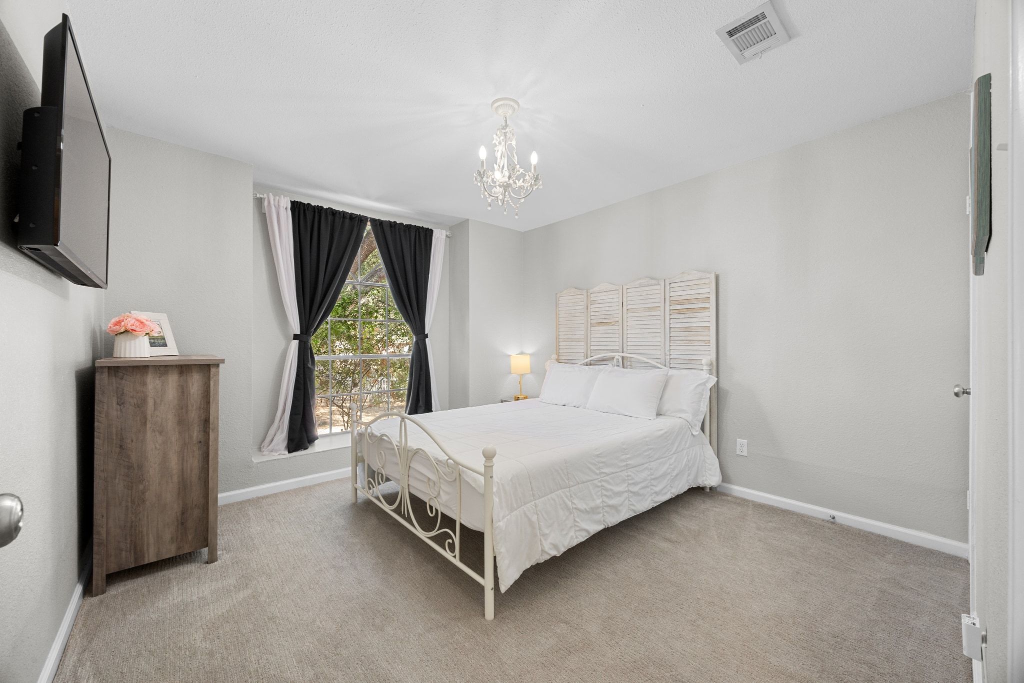 6305 Weeks Cove Austin, TX 78727 - Photo 15 of 30 Bedroom featuring light colored carpet and a chandelier