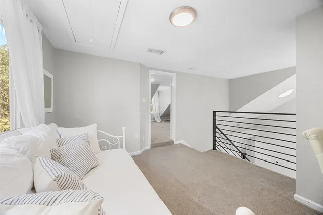 a bedroom with a bed and a couch