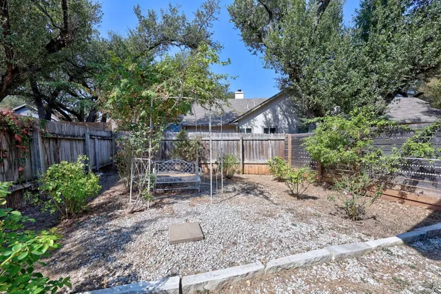 a view of a house with a yard and potted plants