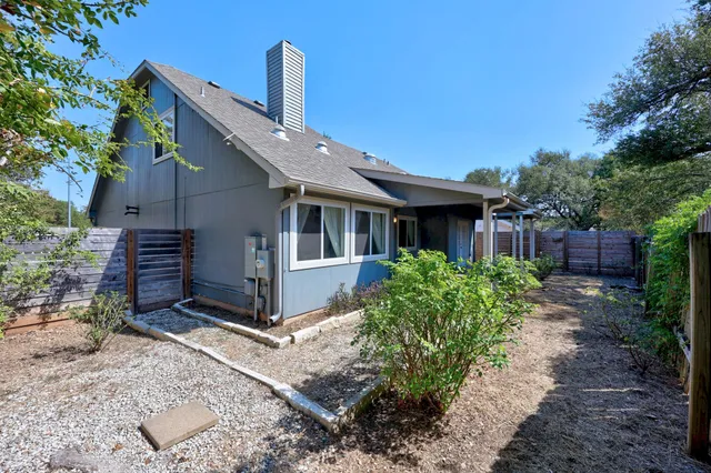 a view of a chair and table in backyard