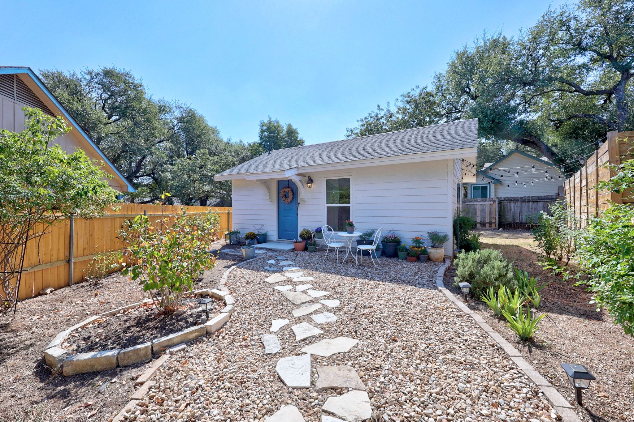 6305 Weeks Cove Austin, TX 78727 - Photo 26 of 30 Rear view of house with a fenced backyard and roof with shingles