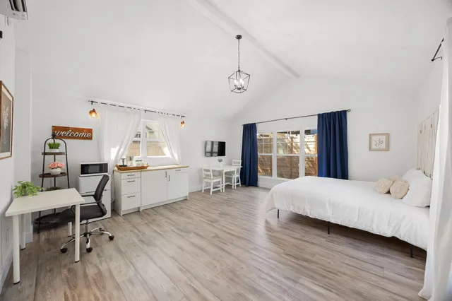 a bedroom with a bed and wooden floor