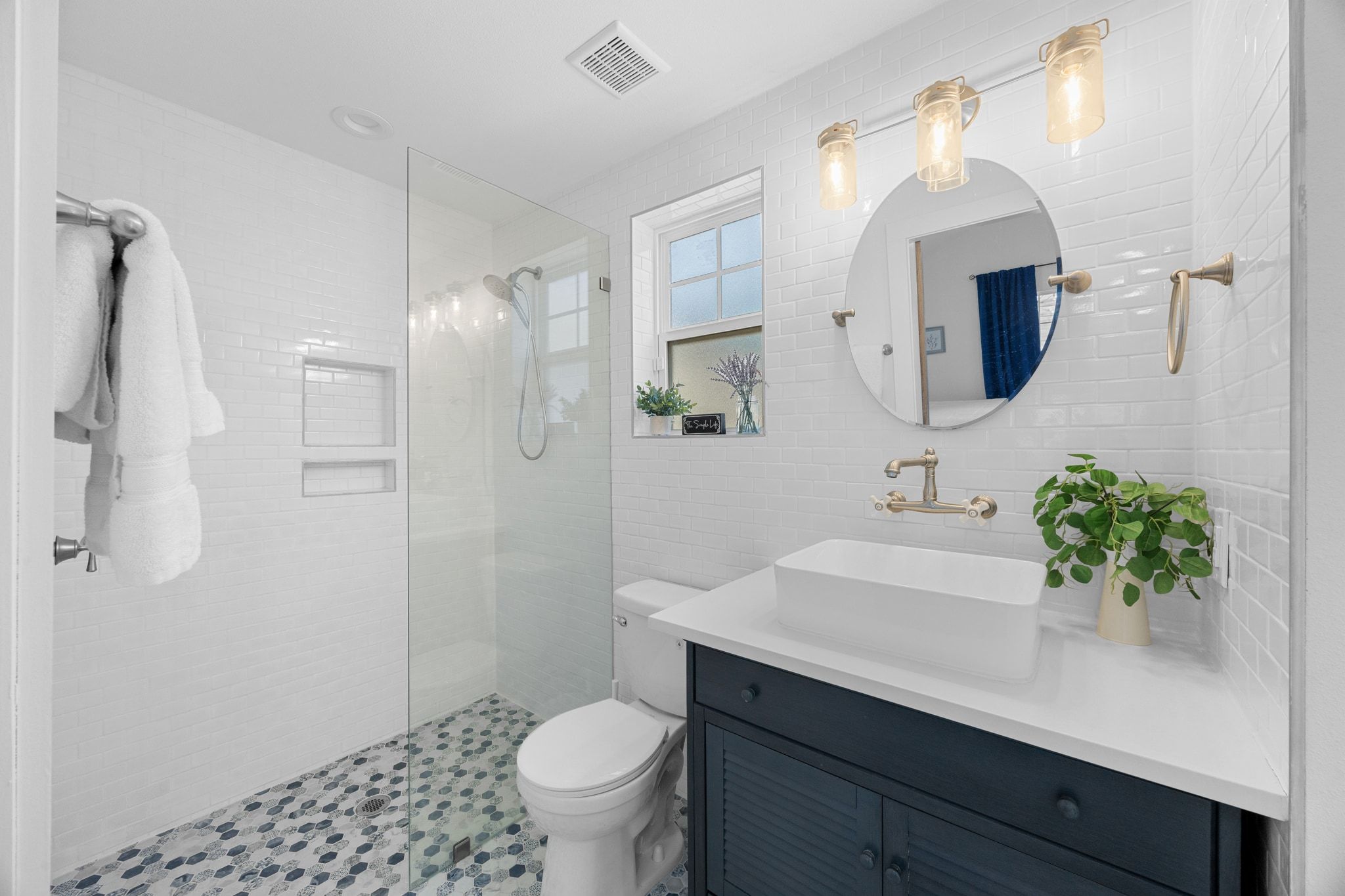 6305 Weeks Cove Austin, TX 78727 - Photo 29 of 30 Bathroom with vanity, a walk in shower, and tile walls