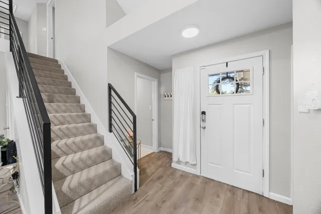 a view of an entryway with wooden floor