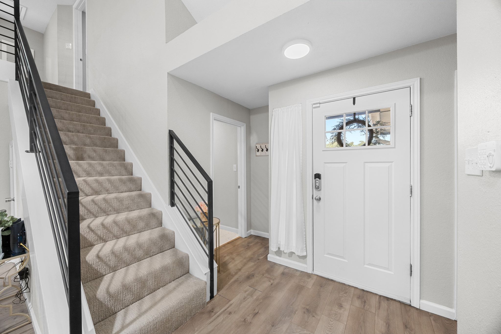6305 Weeks Cove Austin, TX 78727 - Photo 3 of 30 Foyer with light wood-style flooring and stairway