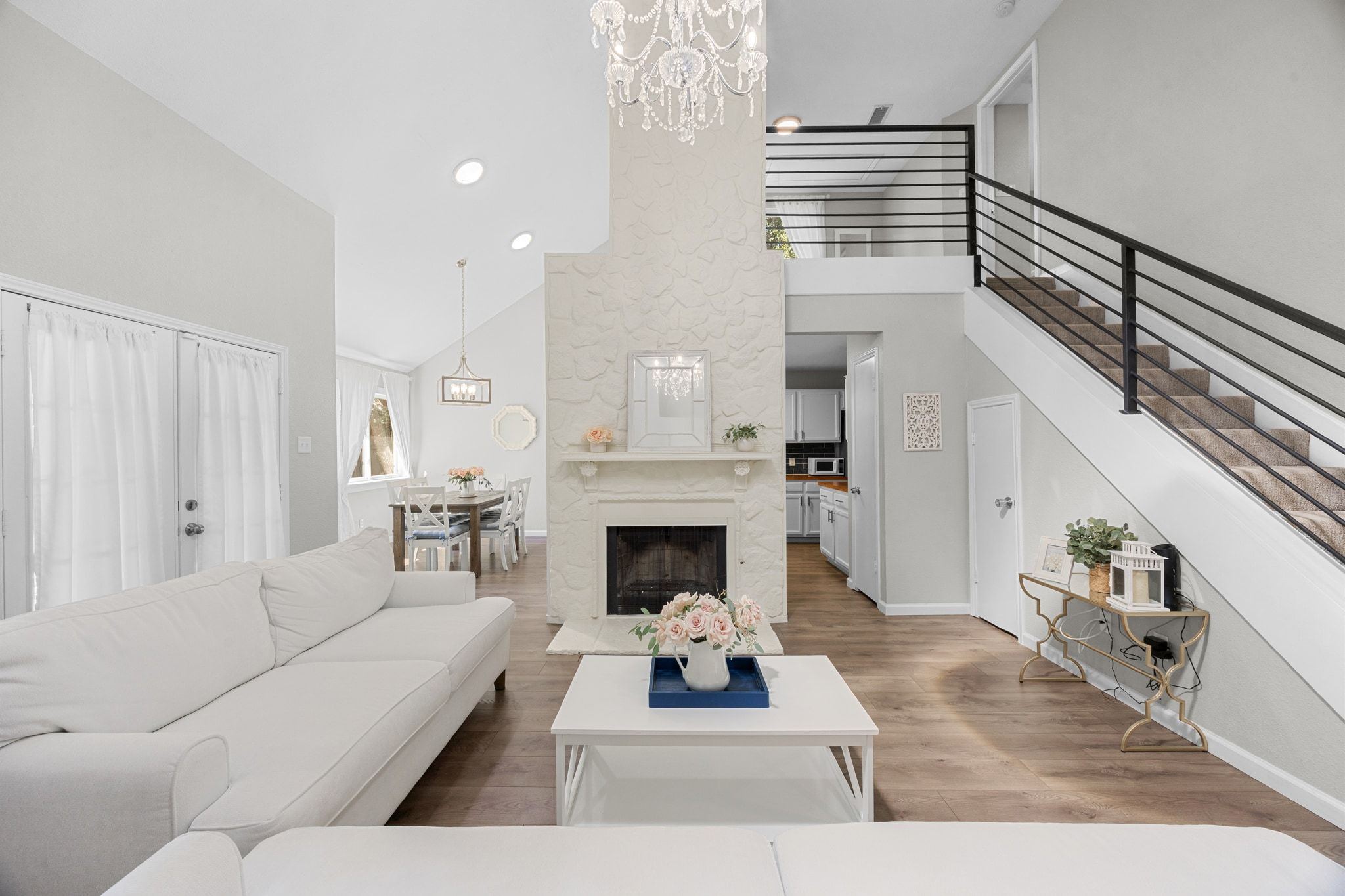 6305 Weeks Cove Austin, TX 78727 - Photo 5 of 30 Living area with high vaulted ceiling, light wood-style floors, a chandelier, recessed lighting, and a fireplace