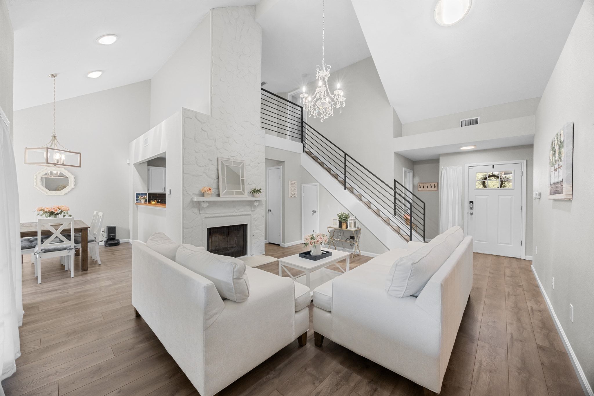6305 Weeks Cove Austin, TX 78727 - Photo 6 of 30 Living area featuring a chandelier, high vaulted ceiling, a large fireplace, light wood-style flooring, and recessed lighting