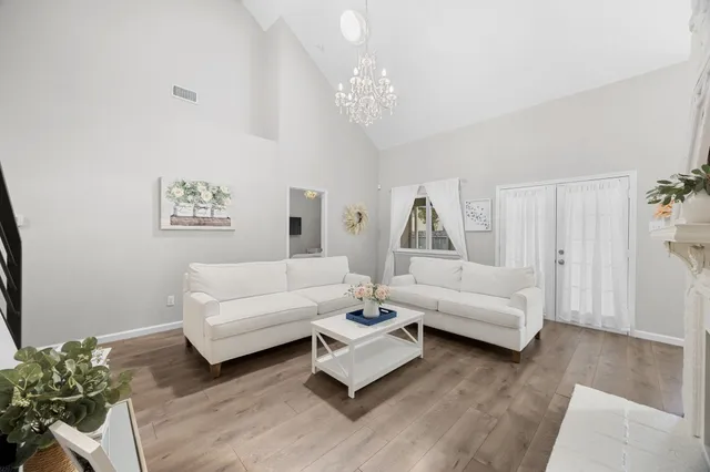 a living room with furniture and a chandelier
