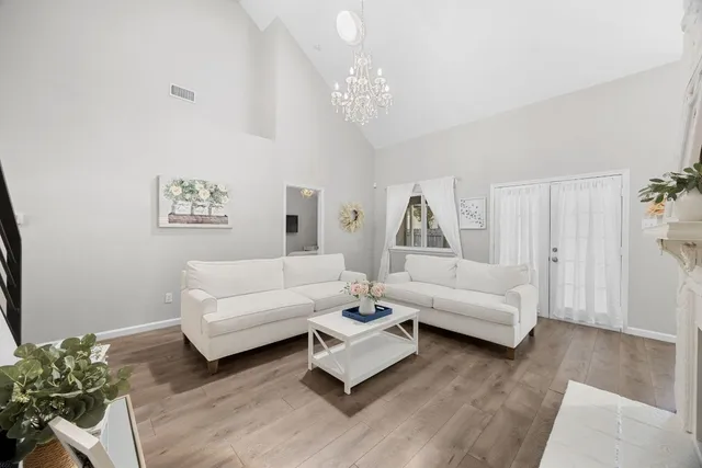 a living room with furniture and a chandelier