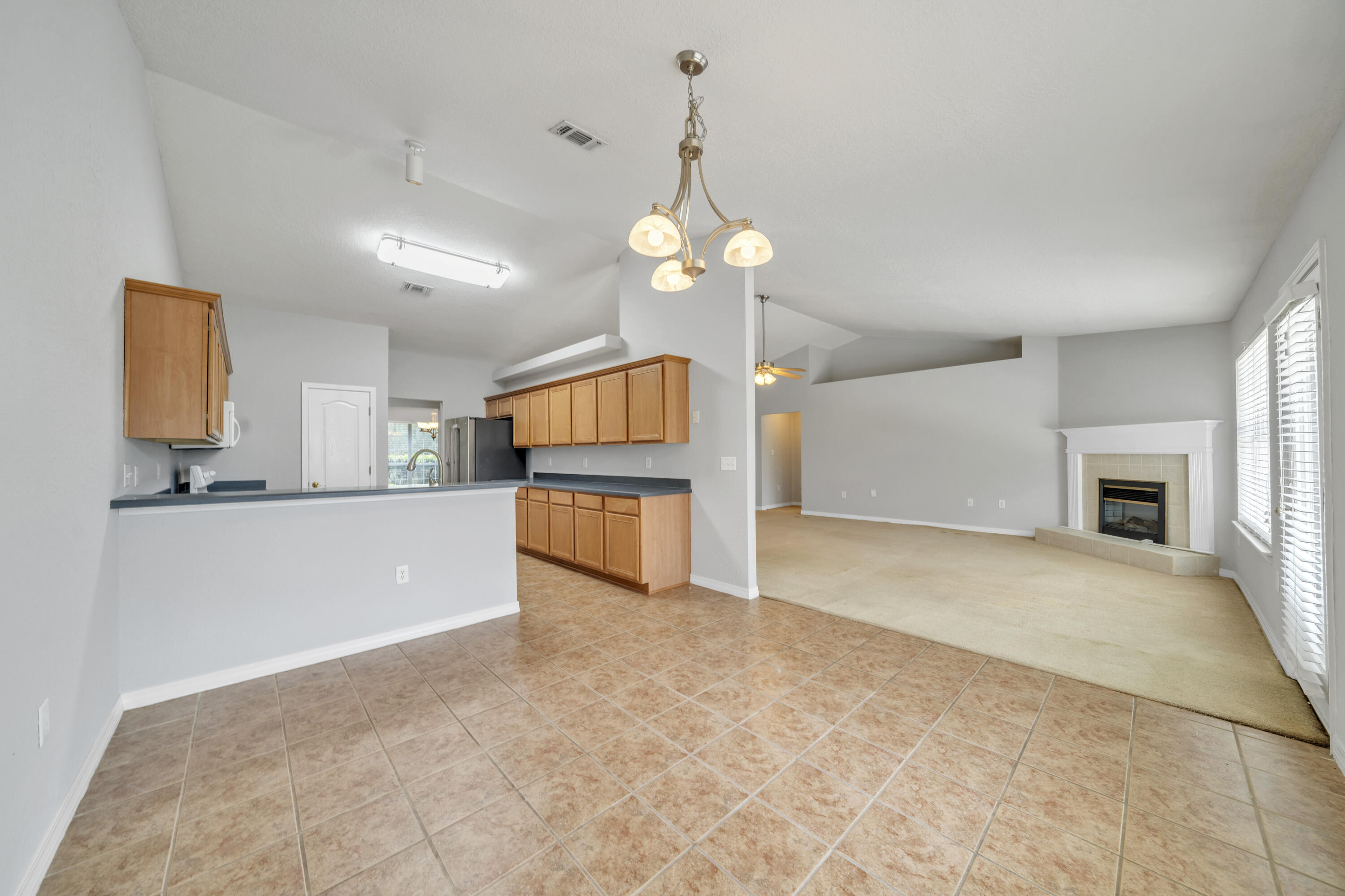 227 East Shipwreck Road Santa Rosa Beach, FL 32459 - Photo 12 of 39 a view of a kitchen with a sink and a chandelier