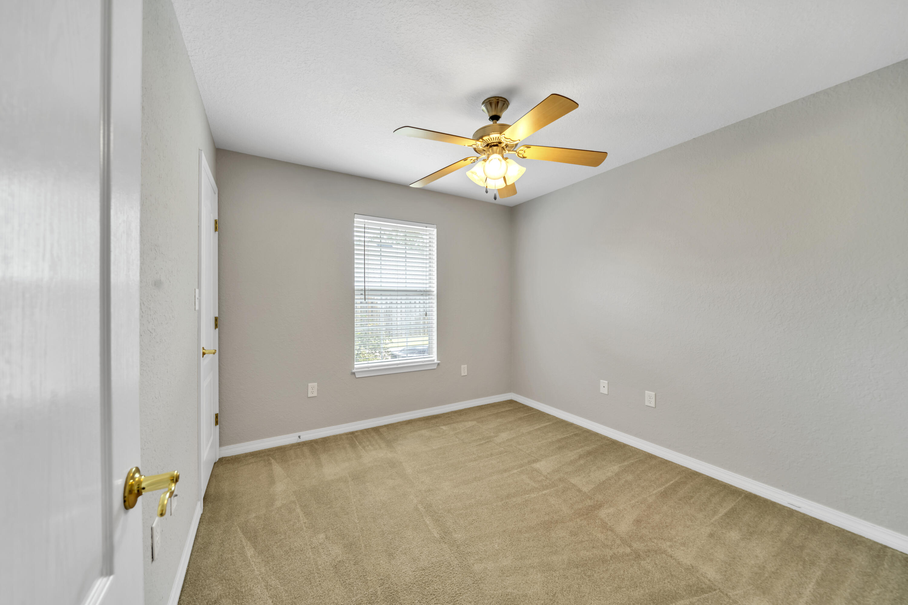 227 East Shipwreck Road Santa Rosa Beach, FL 32459 - Photo 25 of 39 an empty room with windows and chandelier fan
