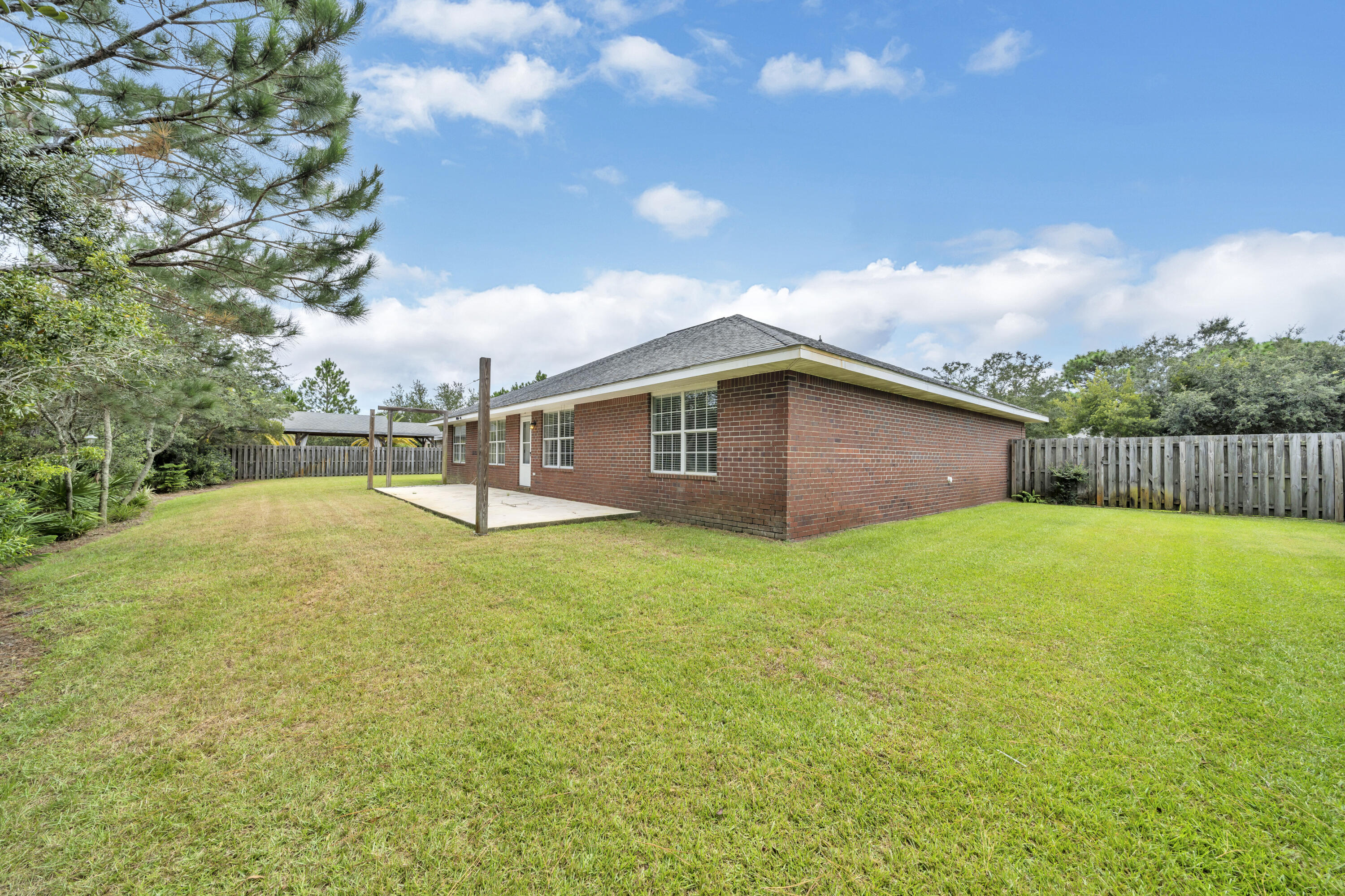 227 East Shipwreck Road Santa Rosa Beach, FL 32459 - Photo 33 of 39 a backyard of a house with lots of green space