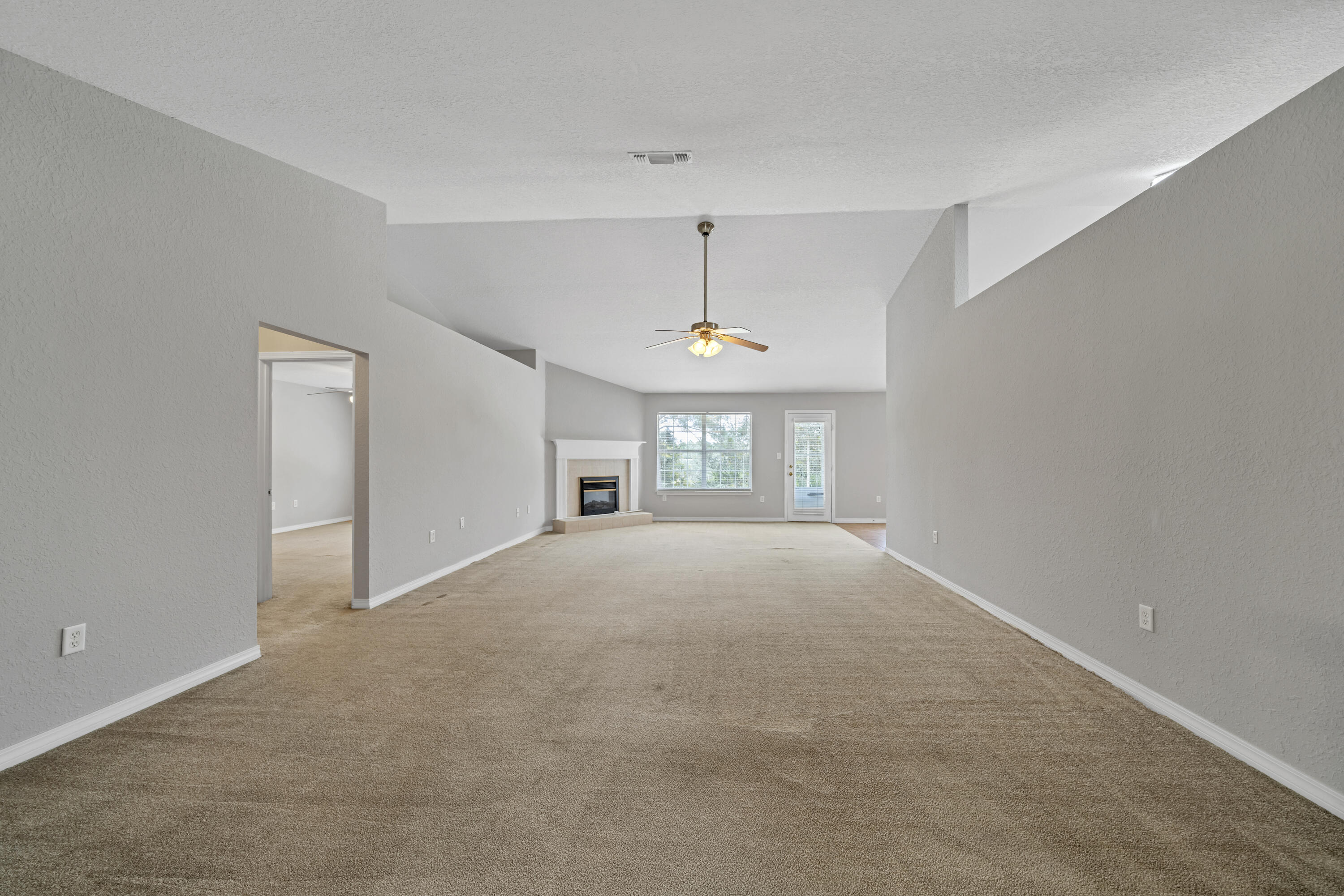 227 East Shipwreck Road Santa Rosa Beach, FL 32459 - Photo 8 of 39 a view of empty room with windows and ceiling fan