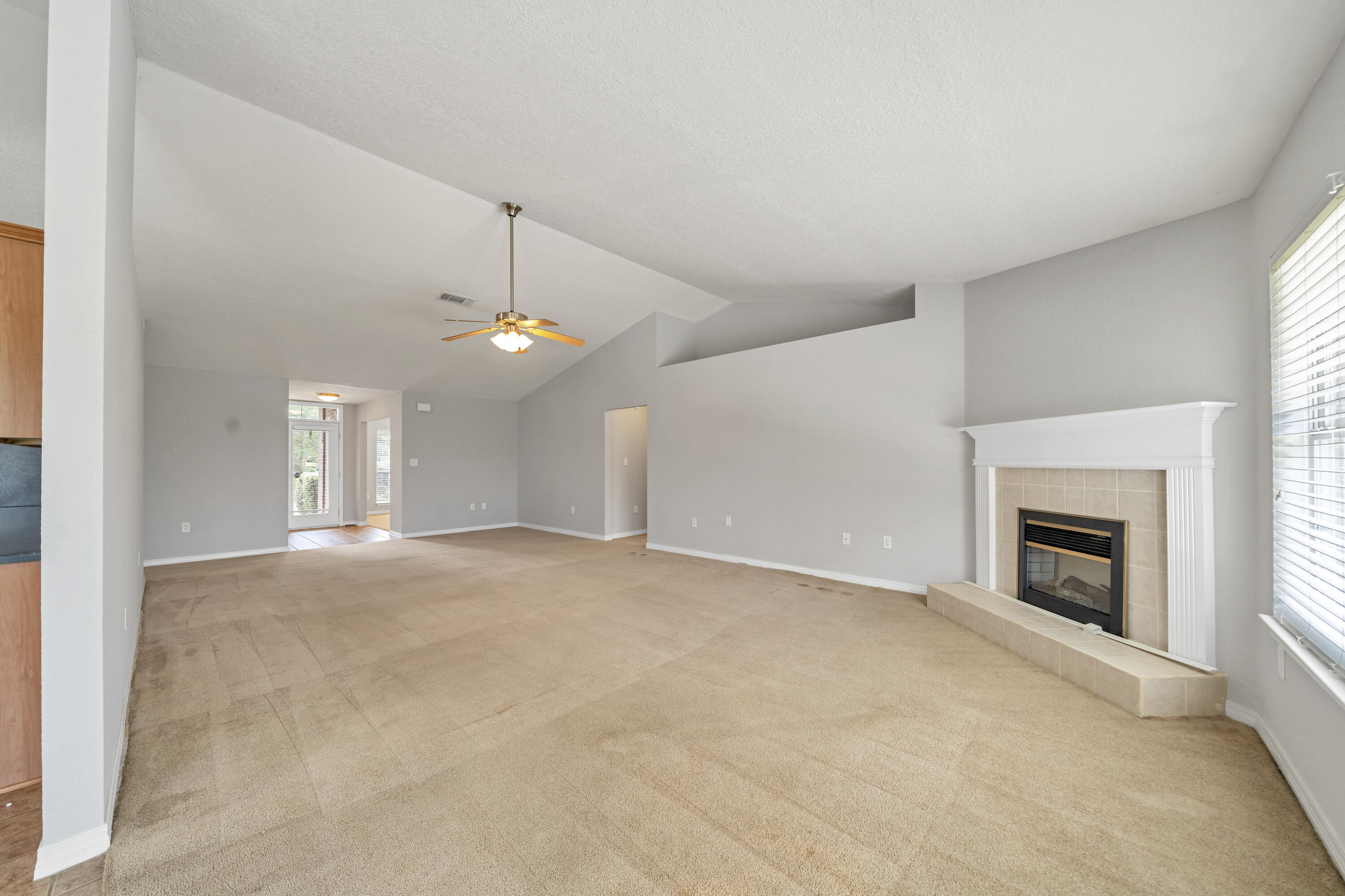 227 East Shipwreck Road Santa Rosa Beach, FL 32459 - Photo 10 of 39 an empty room with fireplace and fan