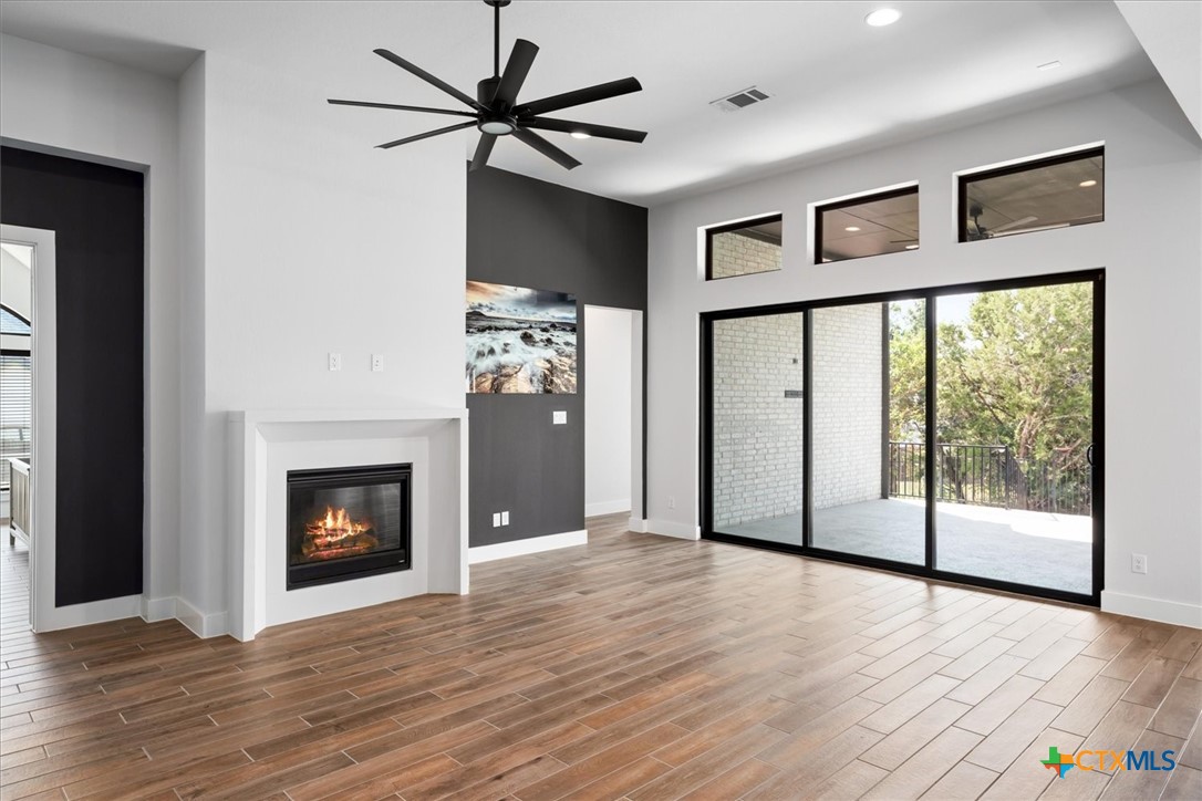 412 Pin Cherry Pass San Marcos, TX 78666 - Photo 11 of 47 a view of an empty room with a fireplace and a window