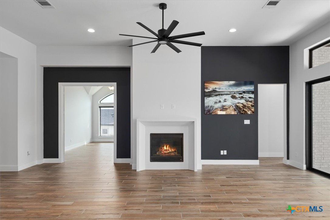 412 Pin Cherry Pass San Marcos, TX 78666 - Photo 15 of 47 a view of a livingroom with a fireplace and a ceiling fan