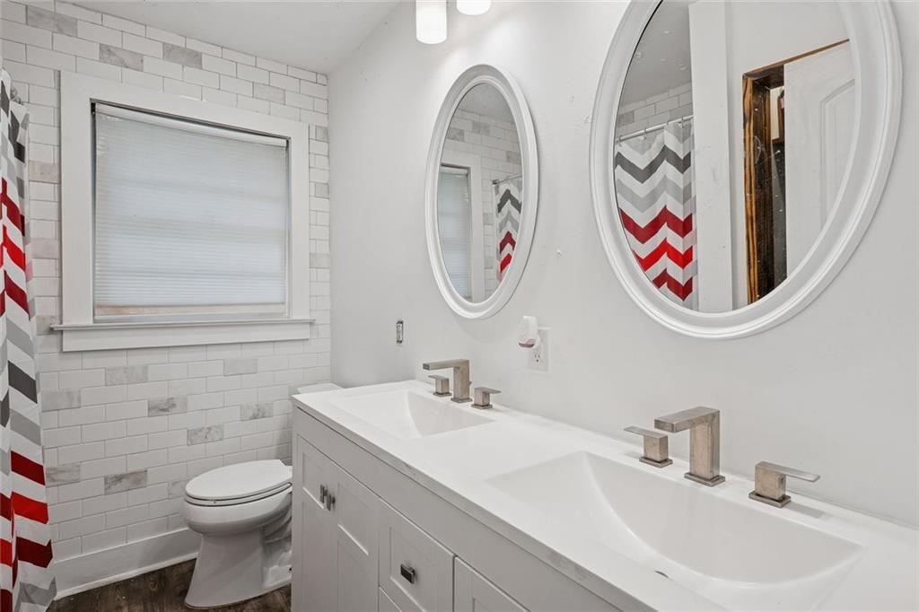 4136 Weelaunee Road Ellenwood, GA 30294 - Photo 12 of 22 a bathroom with a toilet a sink and a mirror