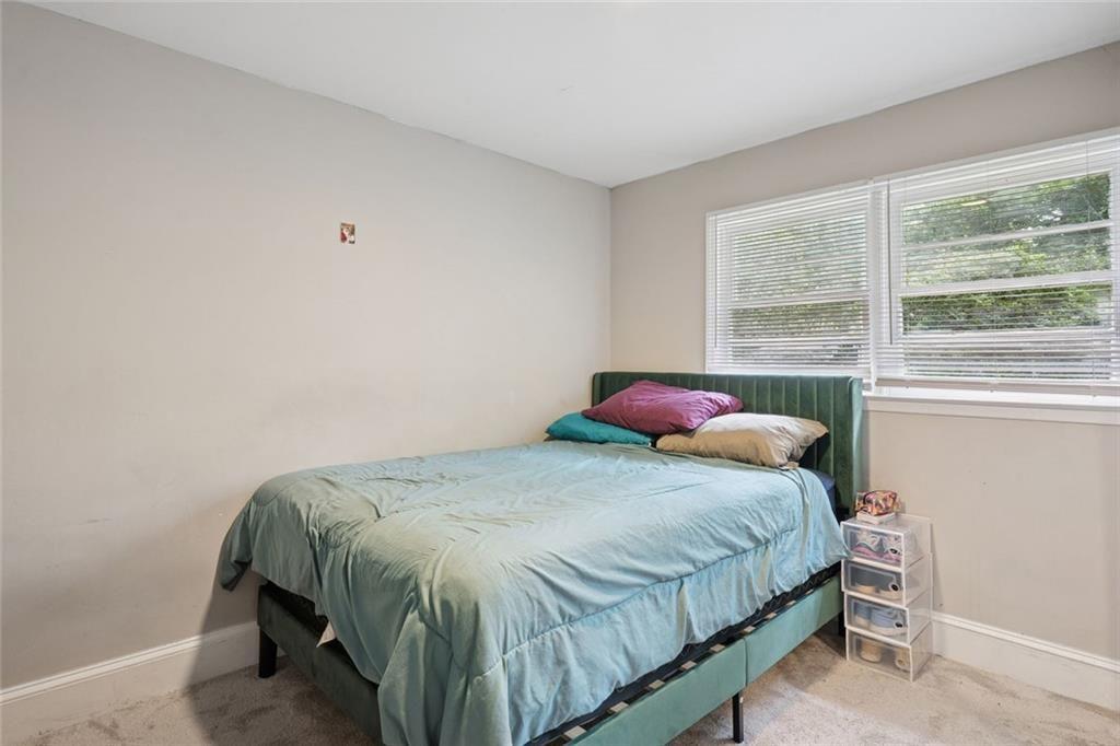 4136 Weelaunee Road Ellenwood, GA 30294 - Photo 13 of 22 a bedroom with a bed and a window