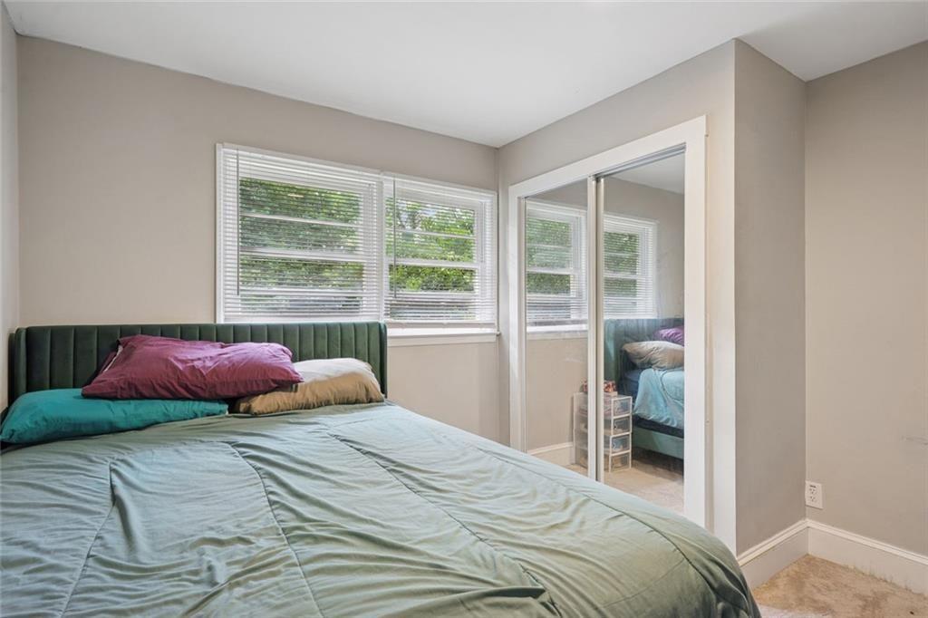 4136 Weelaunee Road Ellenwood, GA 30294 - Photo 14 of 22 a bedroom with a bed and a large window