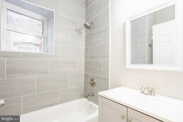 a bathroom with a sink a toilet a shower and a mirror