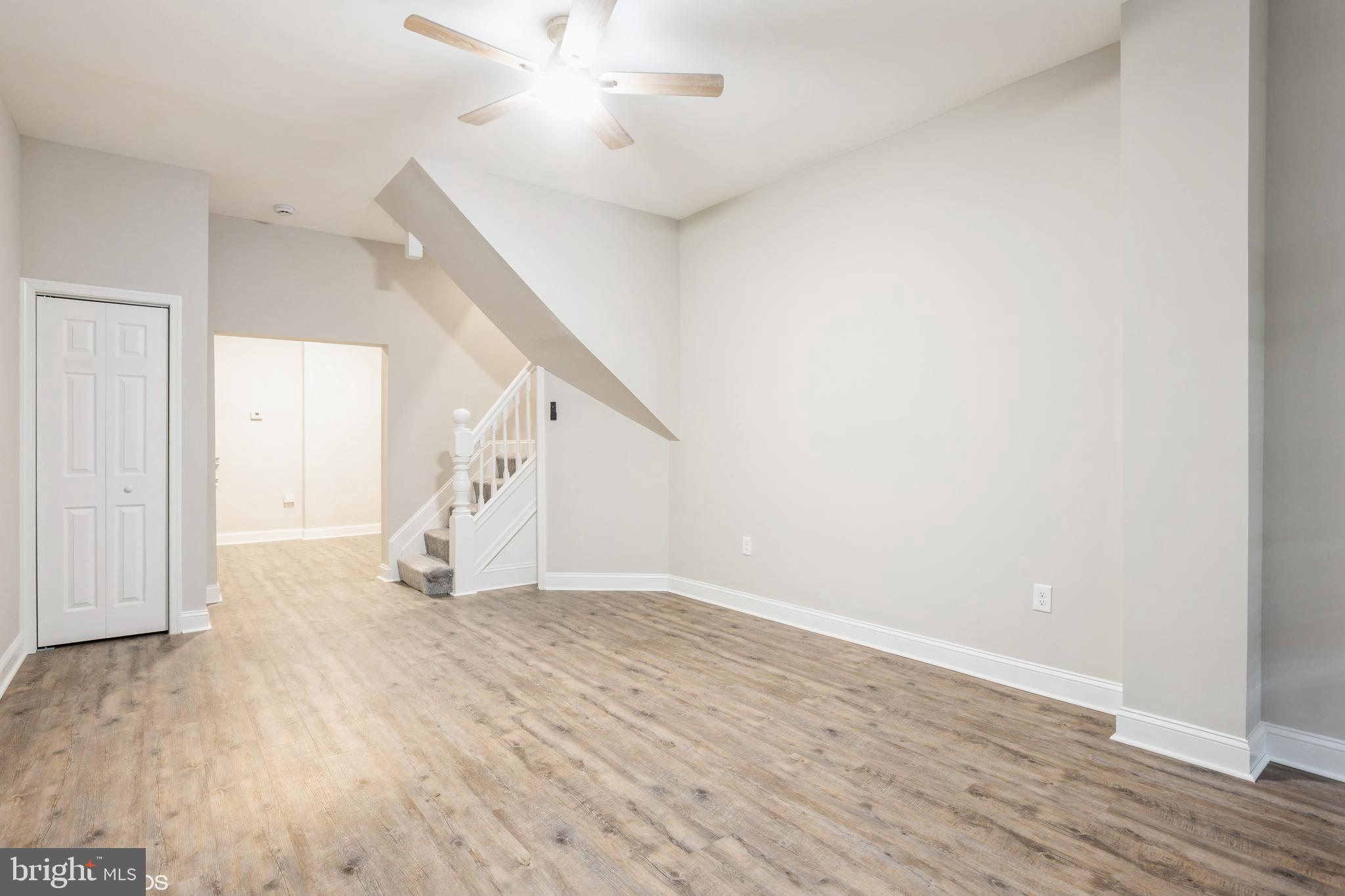 3025 Walbrook Avenue Baltimore, MD 21216 - Photo 3 of 16 an empty room with wooden floor and entryway
