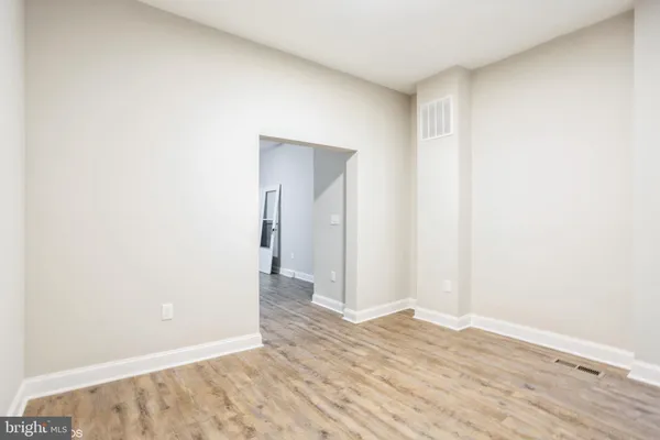 a view of a room with wooden floor