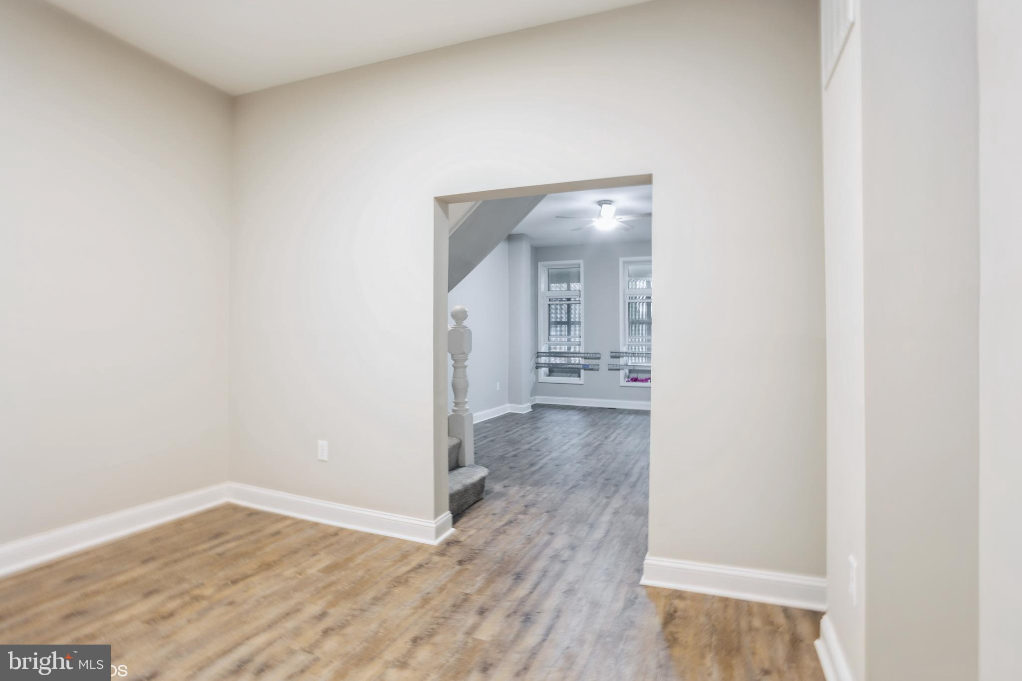 3025 Walbrook Avenue Baltimore, MD 21216 - Photo 5 of 16 a view of a hallway with wooden floor