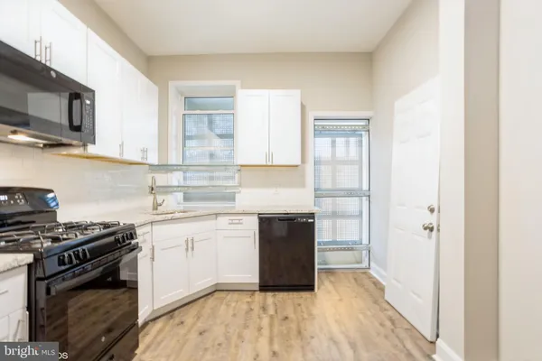 a kitchen with a stove and a refrigerator