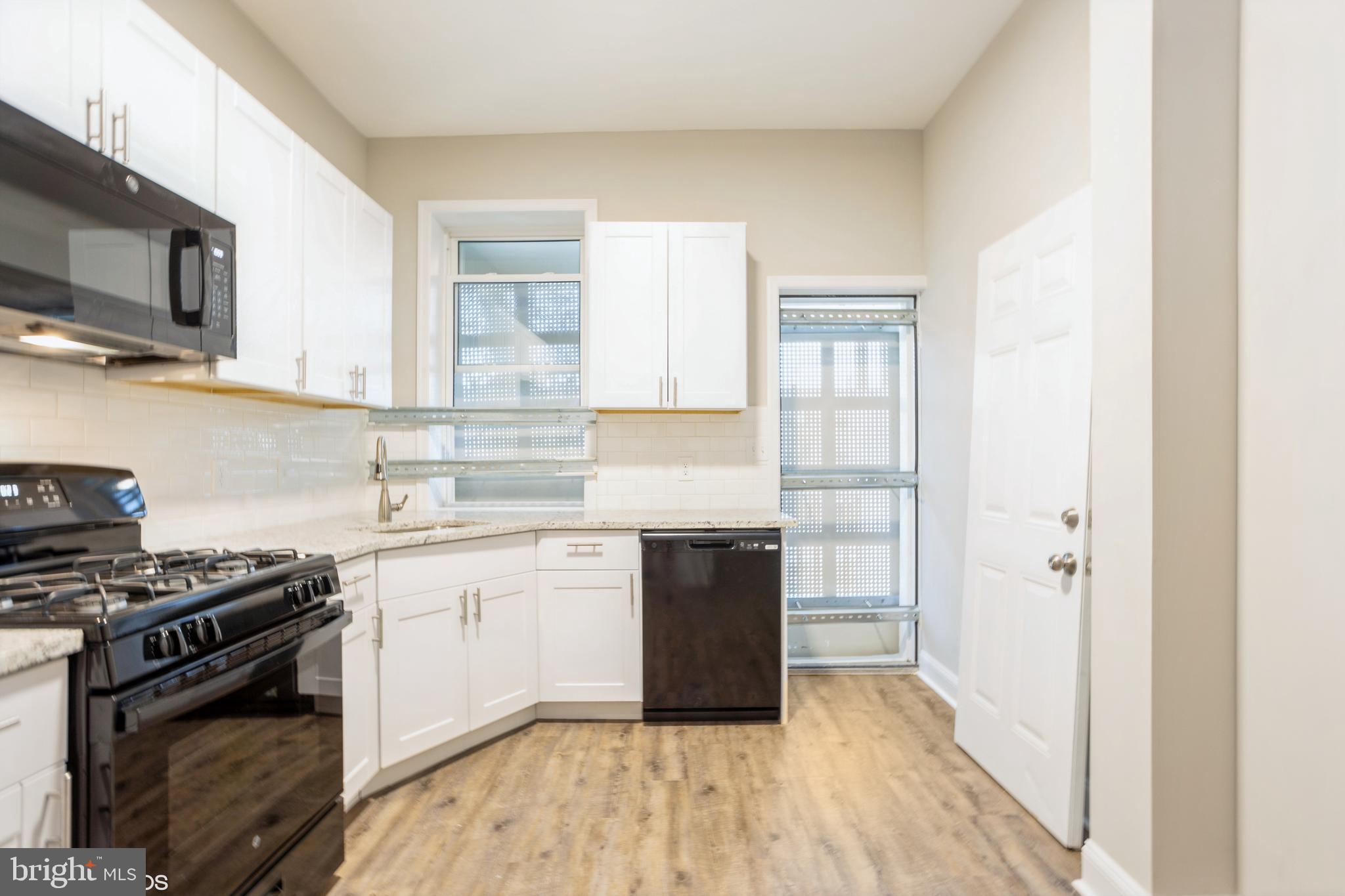 3025 Walbrook Avenue Baltimore, MD 21216 - Photo 6 of 16 a kitchen with a stove and a refrigerator